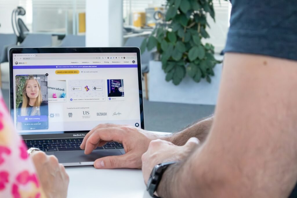 A person working on a laptop in a bright office.